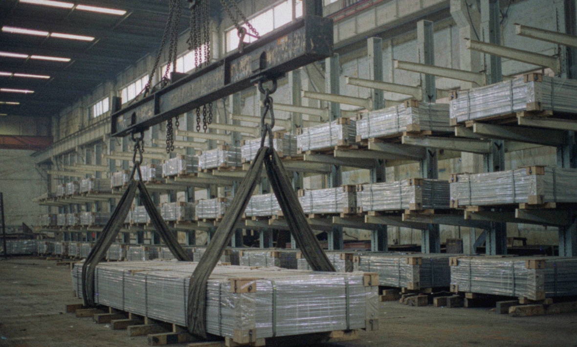 Wide aluminium plate on racking handled by overhead crane